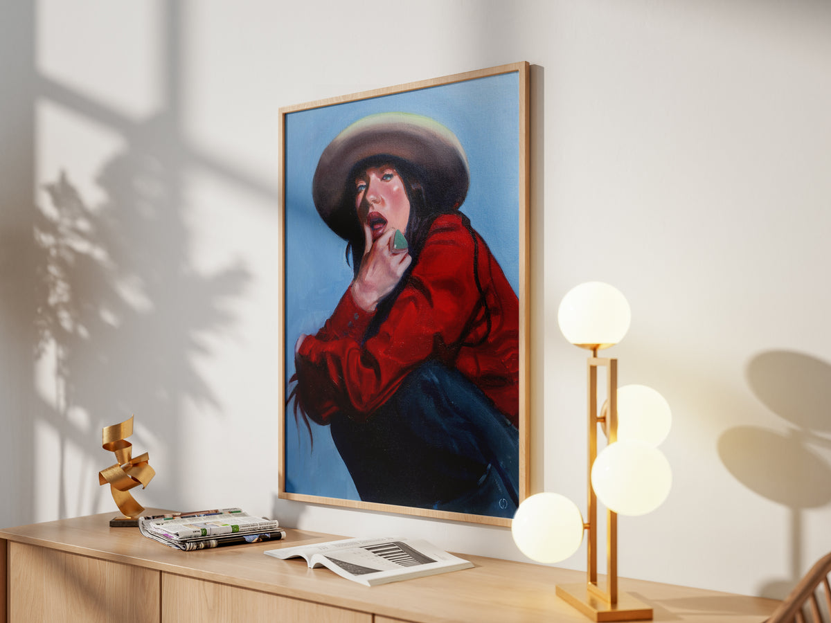 Emily Sulivan #2, framed artwork above a wooden sideboard